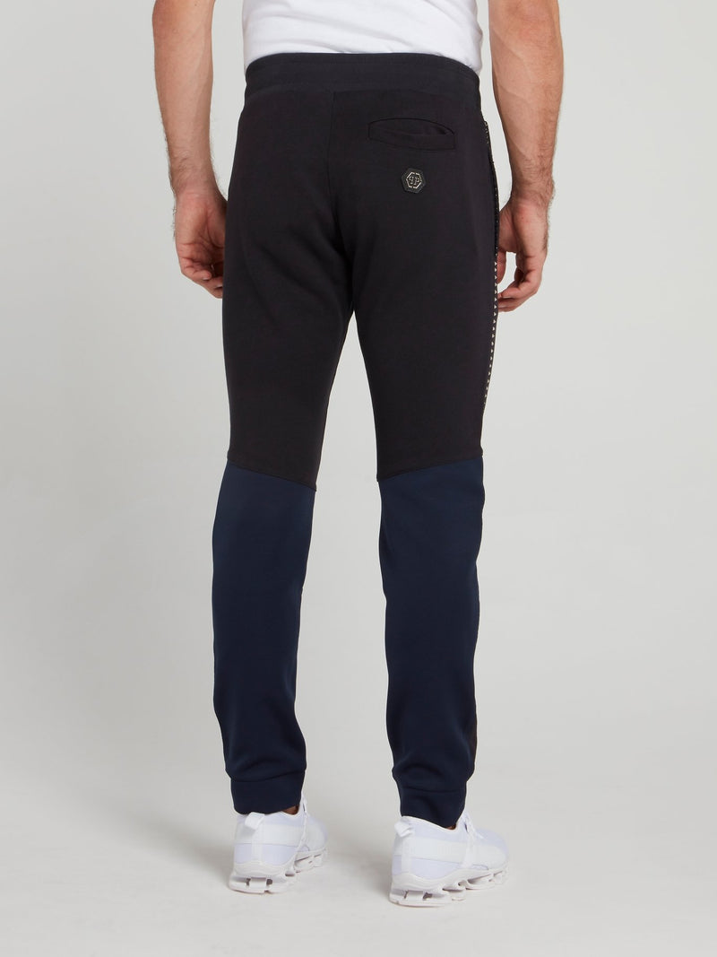 Темно-синие спортивные брюки с рваной отделкой