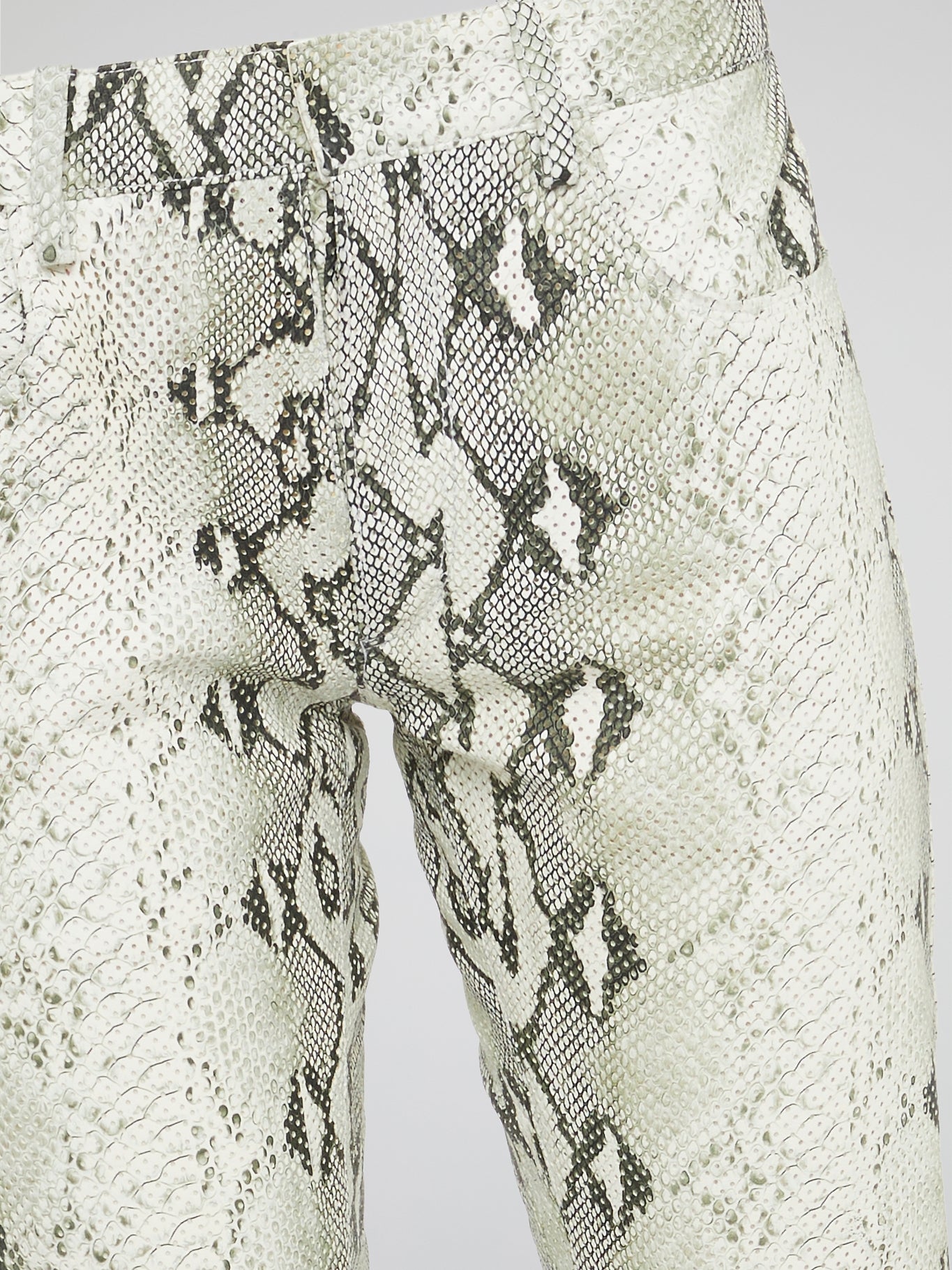 Infuse your wardrobe with a touch of wild sophistication with these snake print skinny trousers from Roberto Cavalli. Crafted from luxurious fabric, these statement pants will elevate any outfit from basic to bold in an instant. Step out in style and turn heads wherever you go with these modern, edgy trousers that exude confidence and glamour.