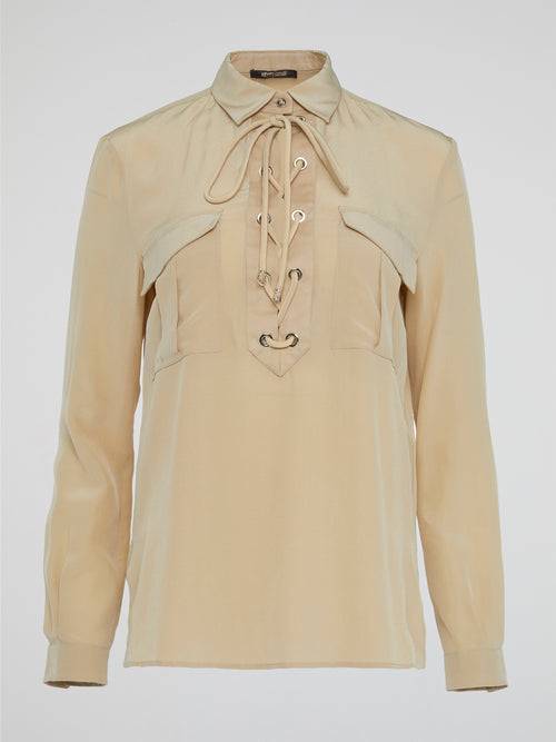 Elevate your wardrobe with the ultimate in luxury and sophistication - the Beige Lace Up Blouse by Roberto Cavalli. Crafted with exquisite attention to detail, this blouse features intricate lace detailing and a flattering silhouette that is sure to turn heads. Embrace your inner fashionista and effortlessly elevate any outfit with this chic and timeless piece.