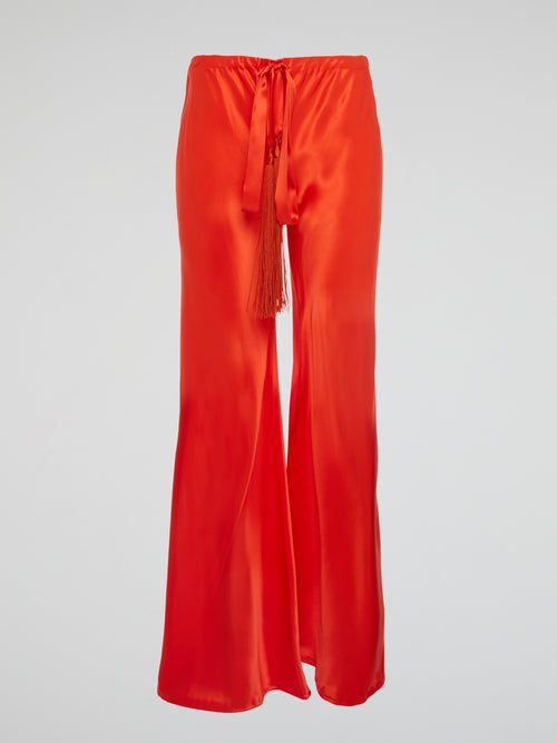 Unleash your inner goddess with these stunning Red Silk Palazzo Pants by Roberto Cavalli. Walk confidently in the flowing silk fabric that drapes elegantly around your legs, exuding luxury and sophistication. Turn heads wherever you go with the bold red color that demands attention and leaves a lasting impression.