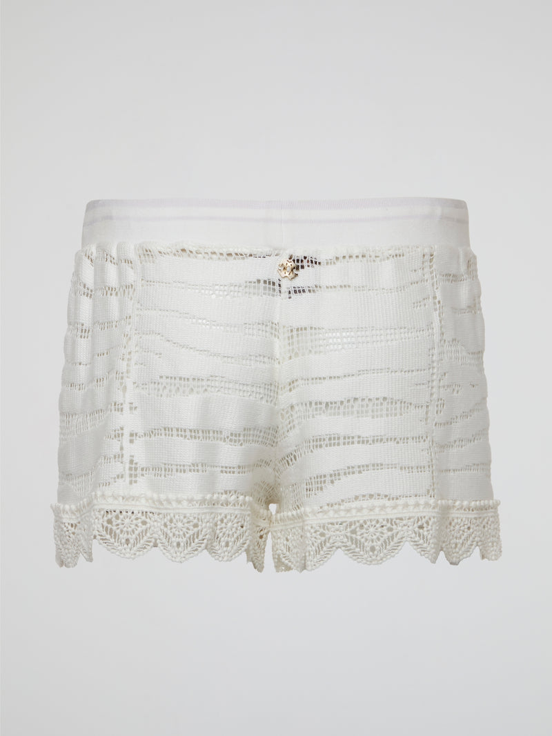 Elevate your summer wardrobe with these stunning white knitted shorts by Roberto Cavalli, perfect for lounging by the pool or a chic brunch with friends. Crafted with impeccable attention to detail, these shorts effortlessly blend comfort and style for a truly luxurious feel. Embrace your inner fashionista and make a statement with these must-have shorts that are sure to turn heads wherever you go.