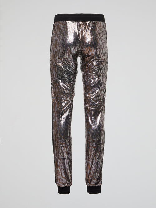 Feel fierce and fabulous in our Leopard Pattern Sequin Pants from Roberto Cavalli. These statement-making bottoms are sure to turn heads wherever you go, with their bold leopard print and shimmering sequins. Channel your inner wild side and stand out from the crowd in these show-stopping pants.