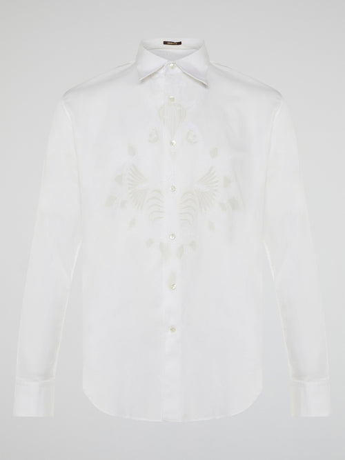 Step into a realm of elegance with the White Embroidered Shirt by Roberto Cavalli, where classic sophistication meets modern charm. Crafted with meticulous attention to detail, this shirt showcases exquisite floral embroidery that dances gracefully across the pristine white fabric. Embrace your inner fashion icon as you effortlessly blend timeless style with a touch of Italian flair, making a statement that is as timeless as it is enchanting.