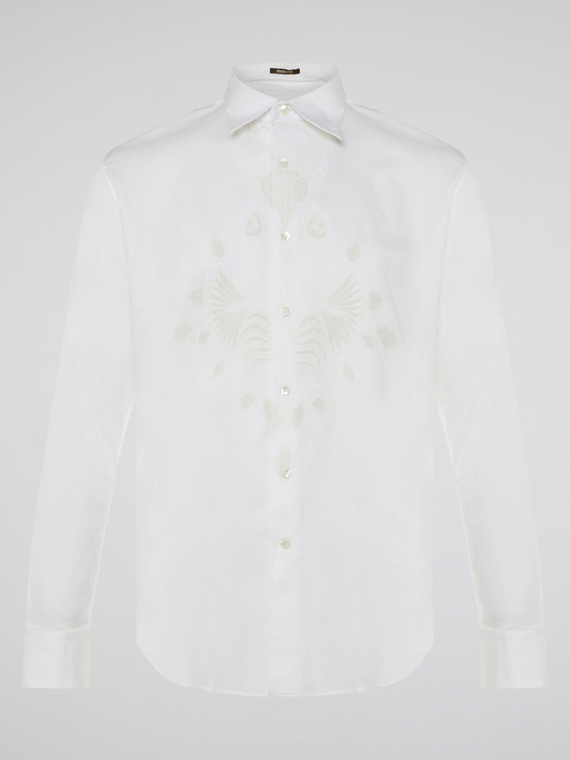 Step into a realm of elegance with the White Embroidered Shirt by Roberto Cavalli, where classic sophistication meets modern charm. Crafted with meticulous attention to detail, this shirt showcases exquisite floral embroidery that dances gracefully across the pristine white fabric. Embrace your inner fashion icon as you effortlessly blend timeless style with a touch of Italian flair, making a statement that is as timeless as it is enchanting.